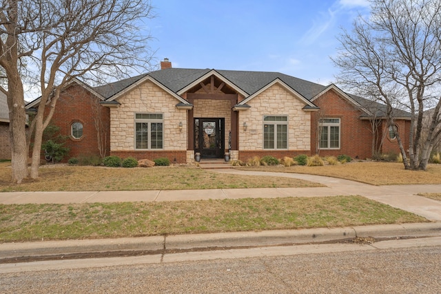 10801 Richmond Ave, Lubbock, TX 79424 - view of front of property featuring stone siding, a chimney, a shingled roof, and brick siding
