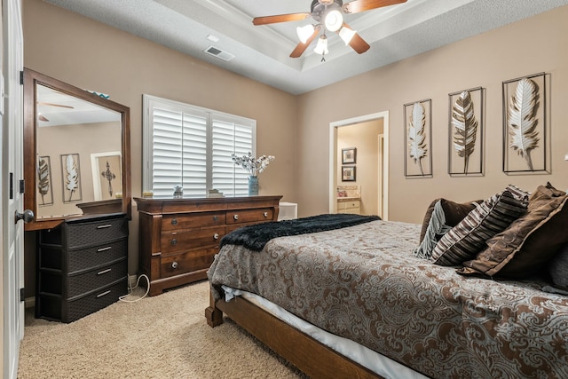 10801 Richmond Ave, Lubbock, TX 79424 - carpeted bedroom with ensuite bath, a tray ceiling, visible vents, and ceiling fan