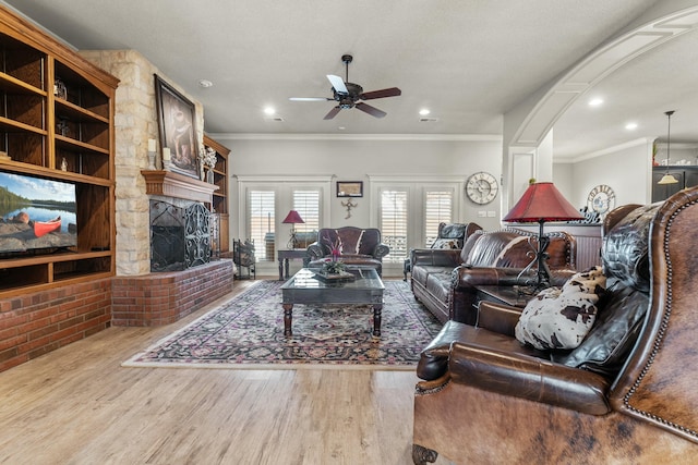 10801 Richmond Ave, Lubbock, TX 79424 - living area with ceiling fan, wood finished floors, ornamental molding, recessed lighting, and a stone fireplace