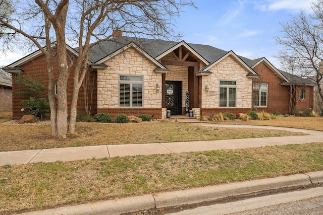 10801 Richmond Ave, Lubbock, TX 79424 - view of front of house featuring a front lawn, a chimney, stone siding, and roof with shingles