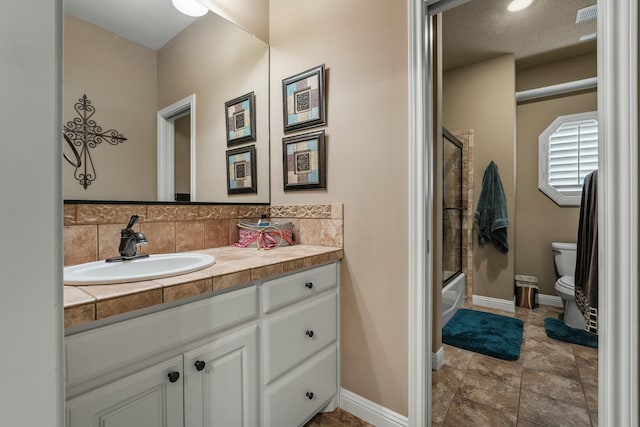 10801 Richmond Ave, Lubbock, TX 79424 - bathroom featuring baseboards, decorative backsplash, toilet, and vanity