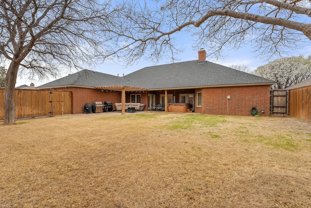 10801 Richmond Ave, Lubbock, TX 79424 - rear view of property with brick siding, a gate, a hot tub, and a patio area