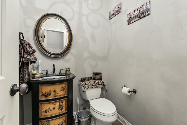 10801 Richmond Ave, Lubbock, TX 79424 - half bathroom featuring baseboards, toilet, and vanity