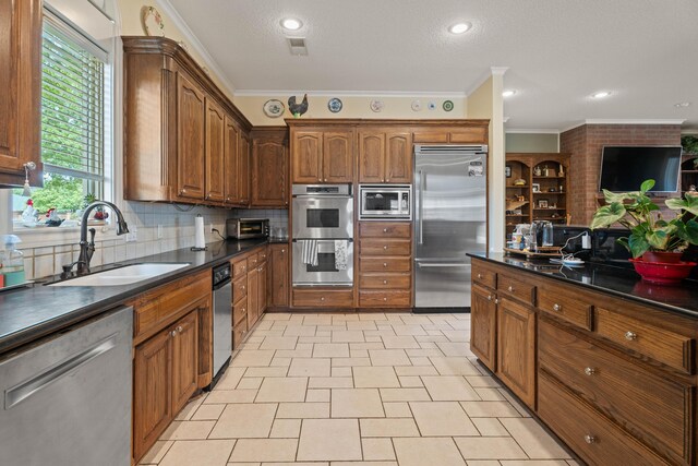 5401 County Rd 1420, Lubbock, TX 79407 - kitchen with built in appliances, dark countertops, crown molding, decorative backsplash, and brown cabinetry