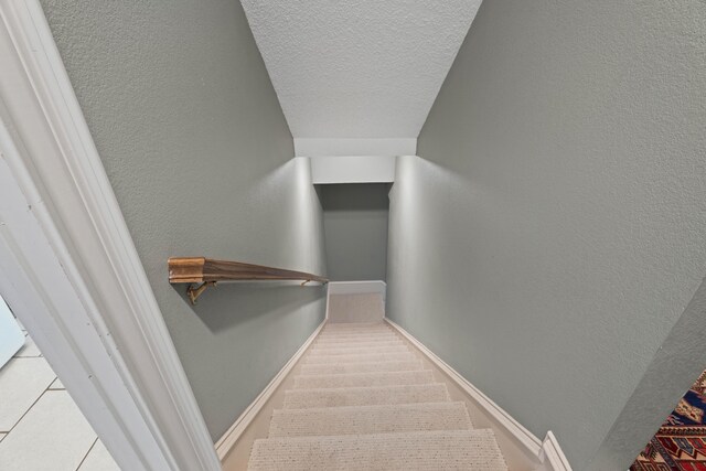5401 County Rd 1420, Lubbock, TX 79407 - stairway with a textured ceiling and a textured wall