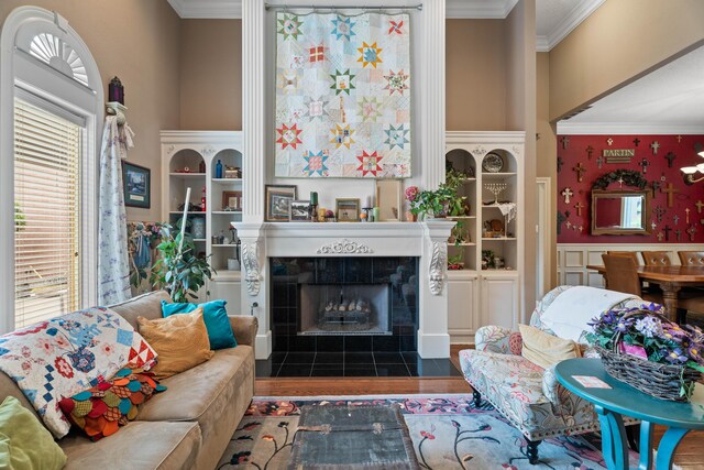 5401 County Rd 1420, Lubbock, TX 79407 - living area featuring crown molding, a tiled fireplace, wood finished floors, and a towering ceiling