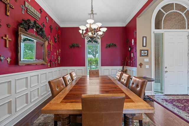 5401 County Rd 1420, Lubbock, TX 79407 - dining space featuring a chandelier, wood finished floors, wainscoting, and ornamental molding