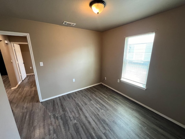 empty room featuring dark wood-type flooring