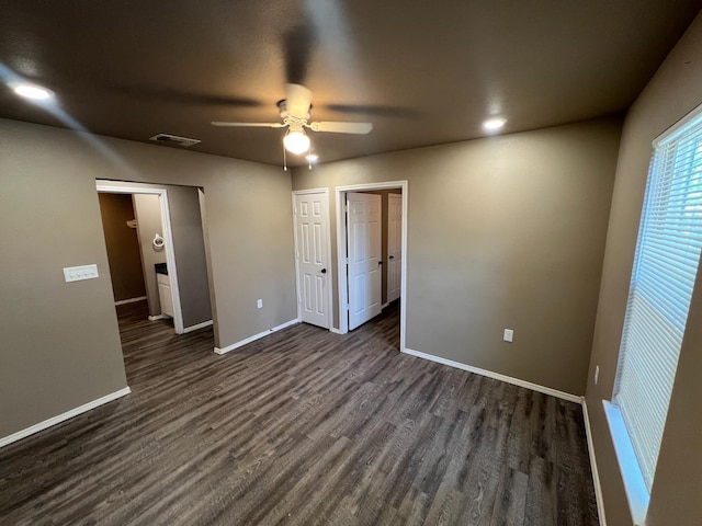 spare room with dark wood-type flooring and ceiling fan