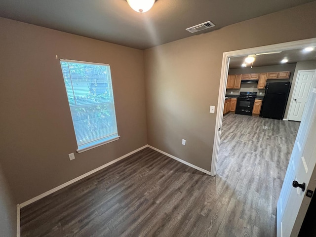 empty room featuring dark hardwood / wood-style flooring