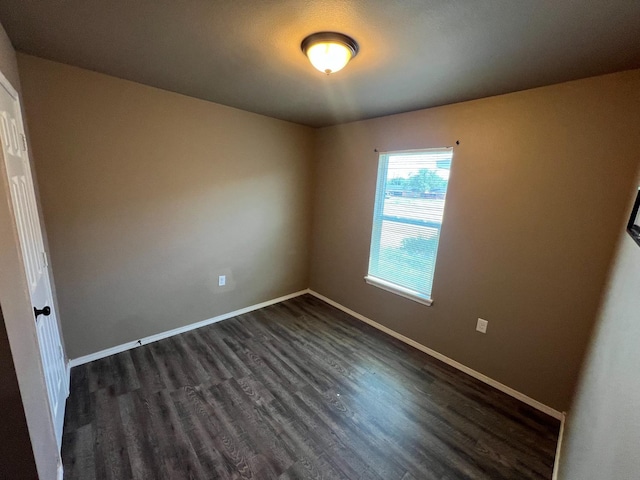 empty room featuring dark wood-type flooring