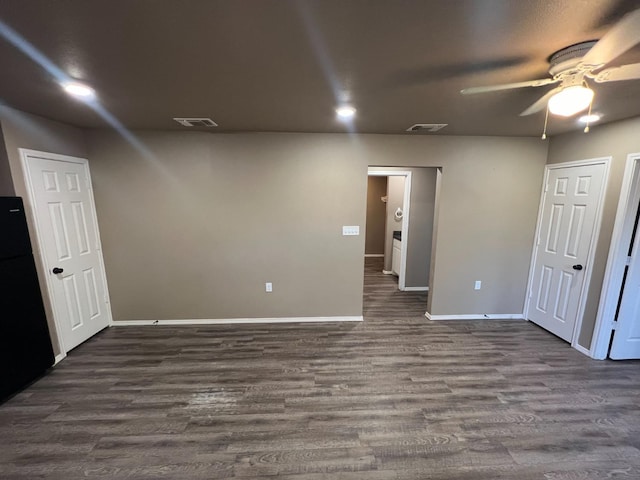 spare room with ceiling fan and dark hardwood / wood-style flooring