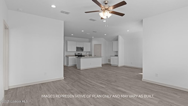 7816 93rd St, Lubbock, TX 79424 - unfurnished living room featuring a ceiling fan, light wood-style floors, and recessed lighting