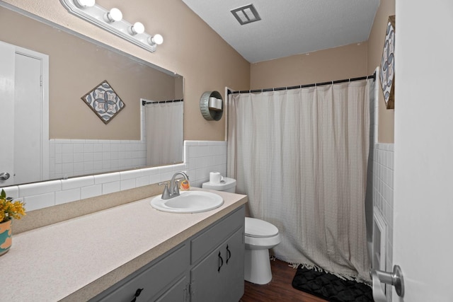 full bathroom featuring vanity, hardwood / wood-style floors, tile walls, and toilet