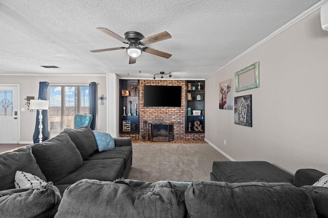 living room featuring crown molding, ceiling fan, a brick fireplace, and a textured ceiling