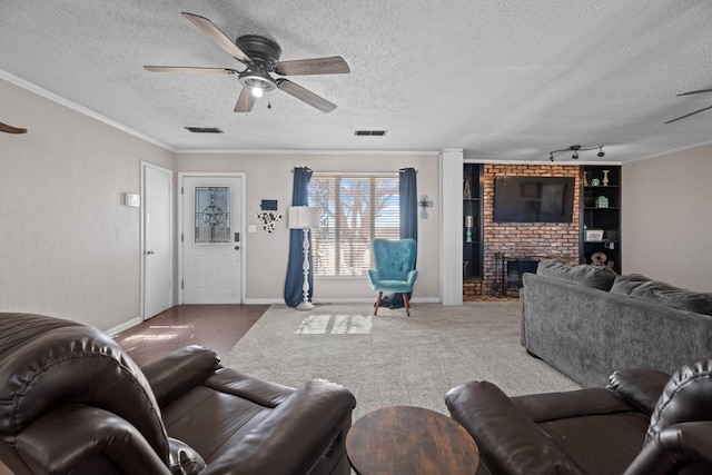 carpeted living room with crown molding, a fireplace, and ceiling fan