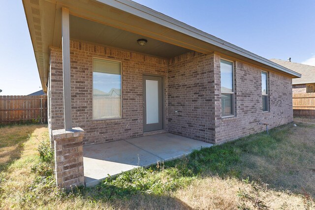 doorway to property with a patio area