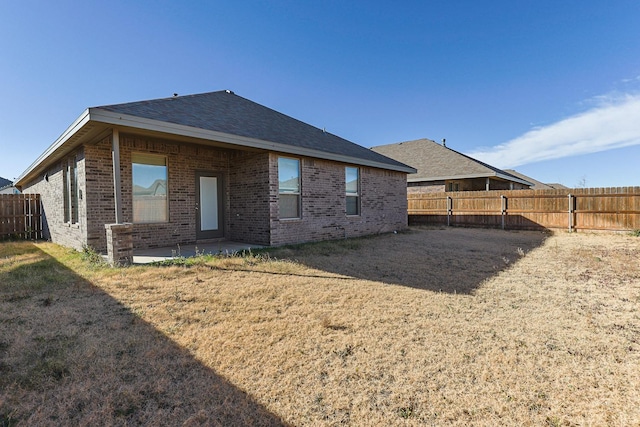 rear view of property with a lawn