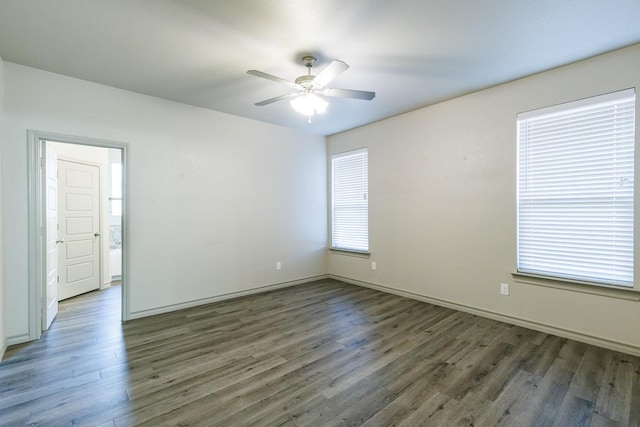 unfurnished room with dark wood-type flooring and ceiling fan