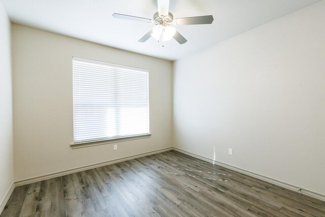 spare room with ceiling fan and dark hardwood / wood-style floors