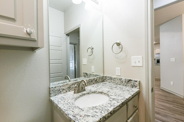 bathroom with vanity and wood-type flooring