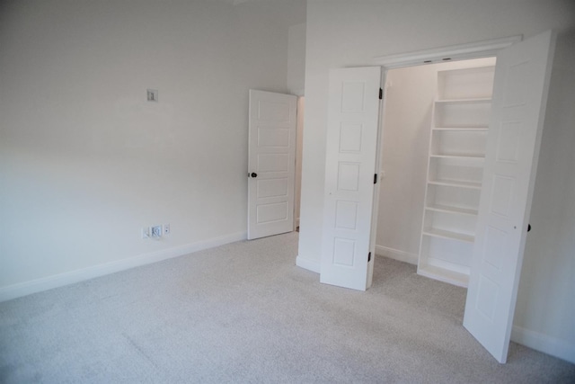 unfurnished bedroom with light colored carpet