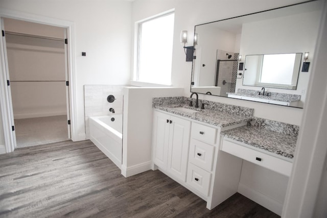 bathroom featuring hardwood / wood-style flooring, shower with separate bathtub, and vanity