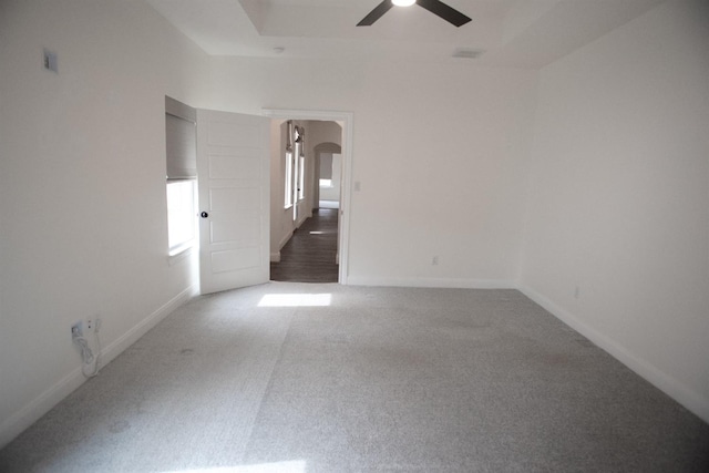 carpeted spare room with ceiling fan