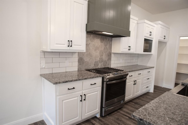 kitchen featuring stone counters, white cabinetry, custom range hood, gas stove, and dark hardwood / wood-style flooring