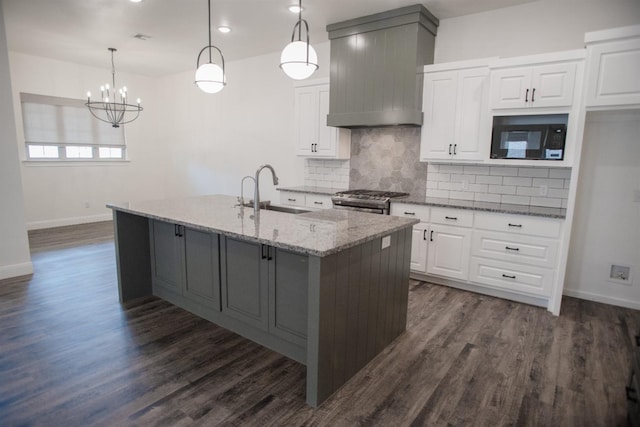 kitchen featuring sink, pendant lighting, and white cabinets