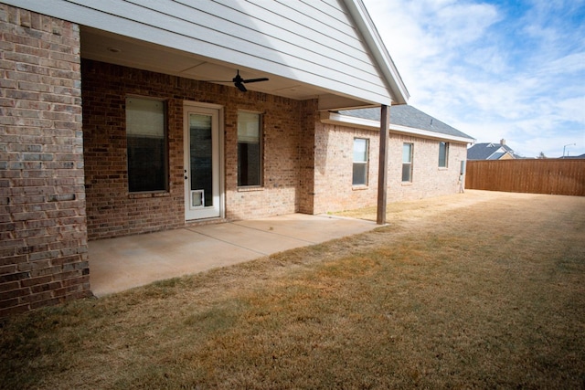 view of yard with ceiling fan and a patio area