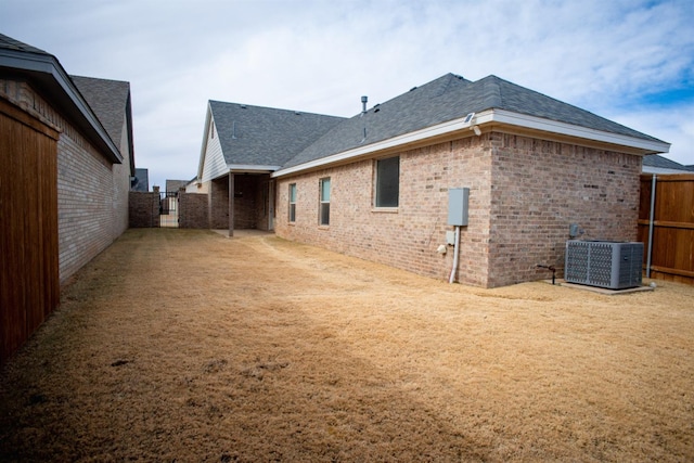 rear view of property featuring central air condition unit