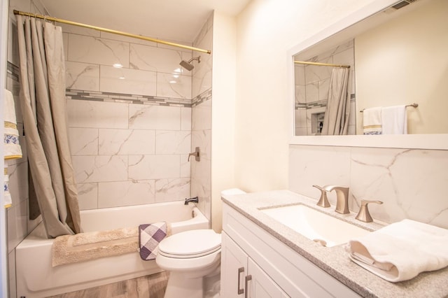 bathroom with toilet, wood finished floors, shower / tub combo, decorative backsplash, and vanity