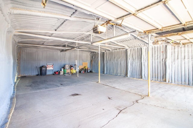 garage featuring metal wall and a garage door opener