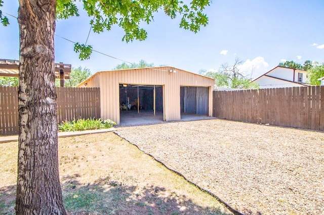 detached garage featuring fence