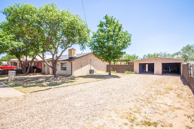 view of property exterior with an outdoor structure, fence, a garage, and a chimney