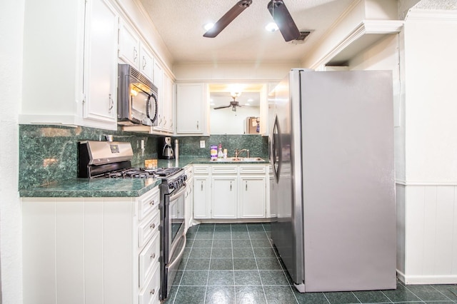 kitchen featuring tasteful backsplash, appliances with stainless steel finishes, ceiling fan, and white cabinetry