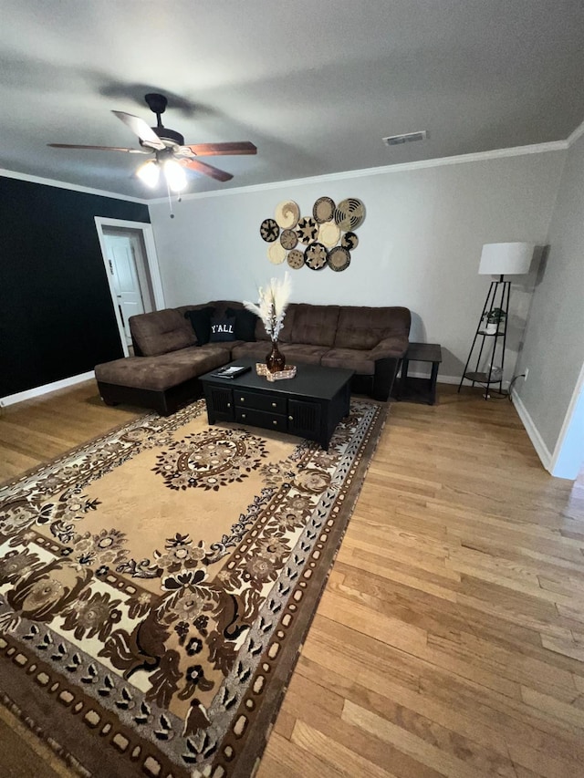 living room with ceiling fan, ornamental molding, and hardwood / wood-style floors