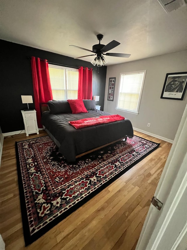 bedroom featuring hardwood / wood-style floors and ceiling fan