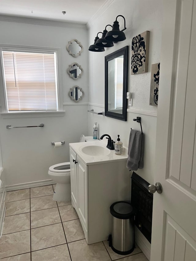 bathroom with vanity, ornamental molding, a tub to relax in, tile patterned floors, and toilet