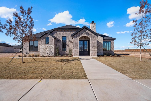 view of front of property featuring french doors and a front yard