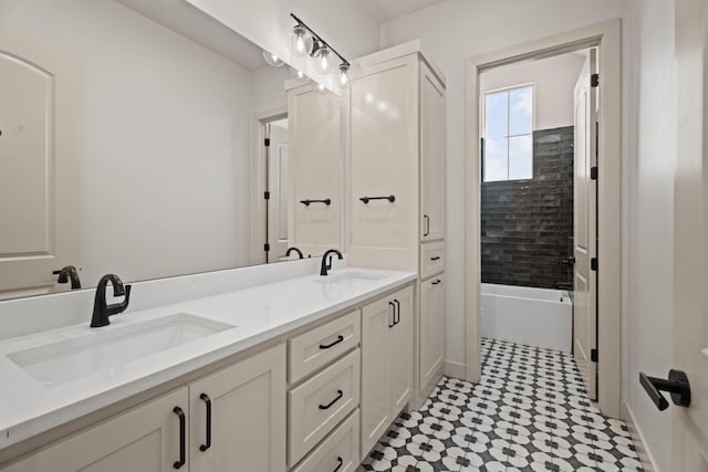 bathroom featuring tiled shower / bath and vanity