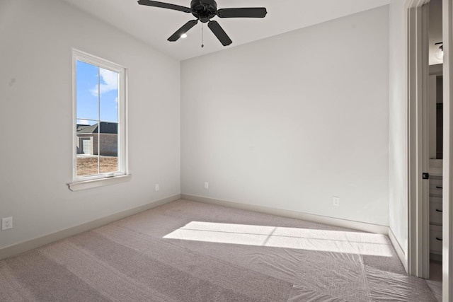 carpeted empty room featuring ceiling fan and a healthy amount of sunlight