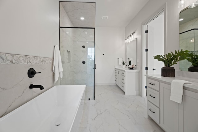 bathroom featuring vanity and separate shower and tub