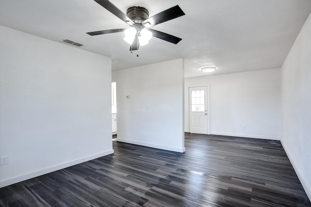 spare room with ceiling fan and dark hardwood / wood-style floors