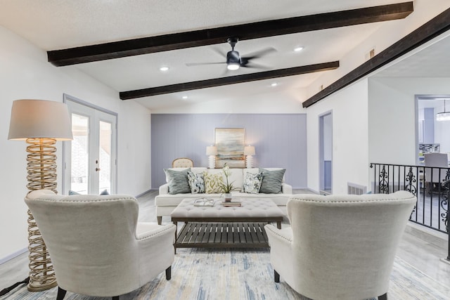 living room with french doors, light wood-type flooring, vaulted ceiling with beams, and ceiling fan