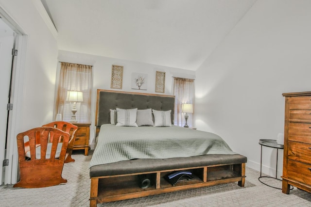 bedroom featuring vaulted ceiling and carpet flooring