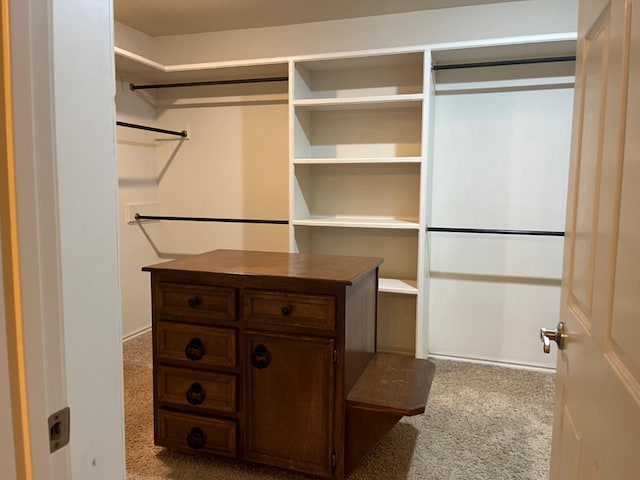 walk in closet featuring carpet flooring