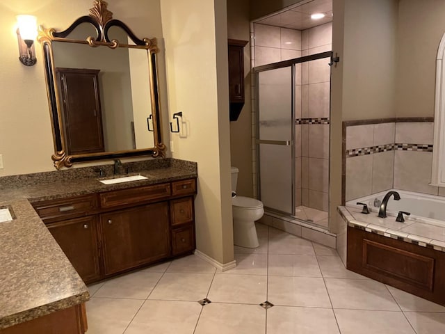 full bathroom with tile patterned flooring, vanity, shower with separate bathtub, and toilet