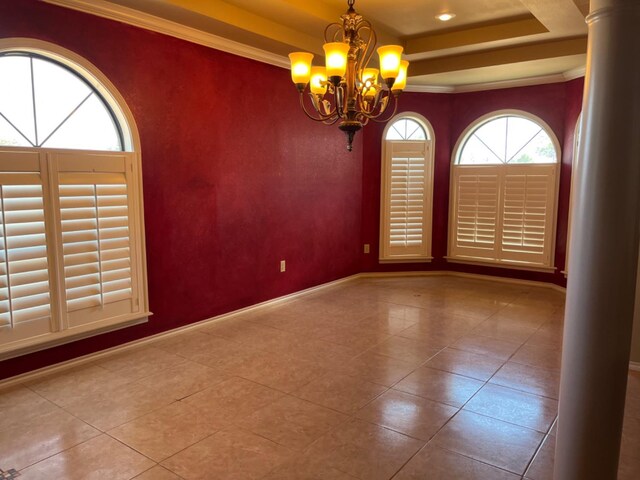 empty room featuring a chandelier, crown molding, a raised ceiling, and tile patterned flooring